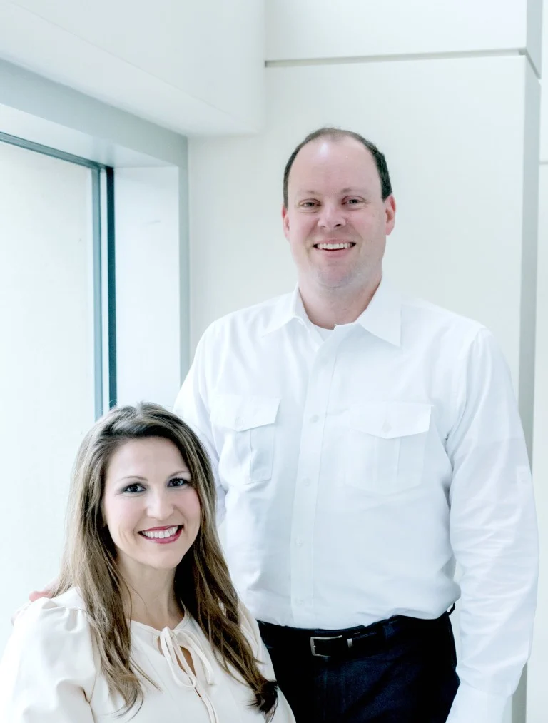 Don and Serra Deville in a bright office