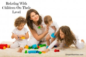 Beauty mom playing with her kids home and sitting together on fur carpet