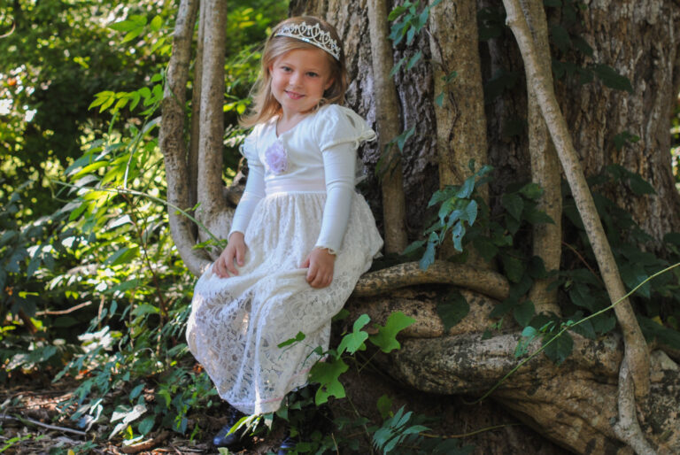 Child wearing a hat while playing outdoors, representing spring nanny care in Savannah
