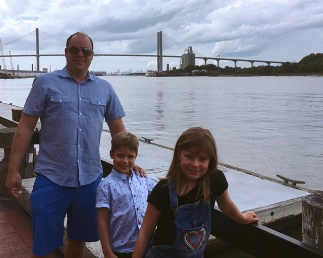Man with two children on the Savannah riverfront