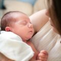 Newborn care specialist in Charlotte soothing a sleeping infant at night