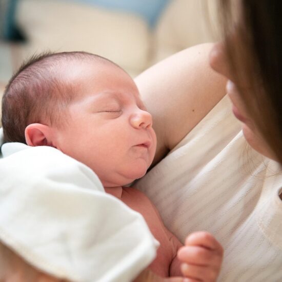 Newborn care specialist in Charlotte soothing a sleeping infant at night