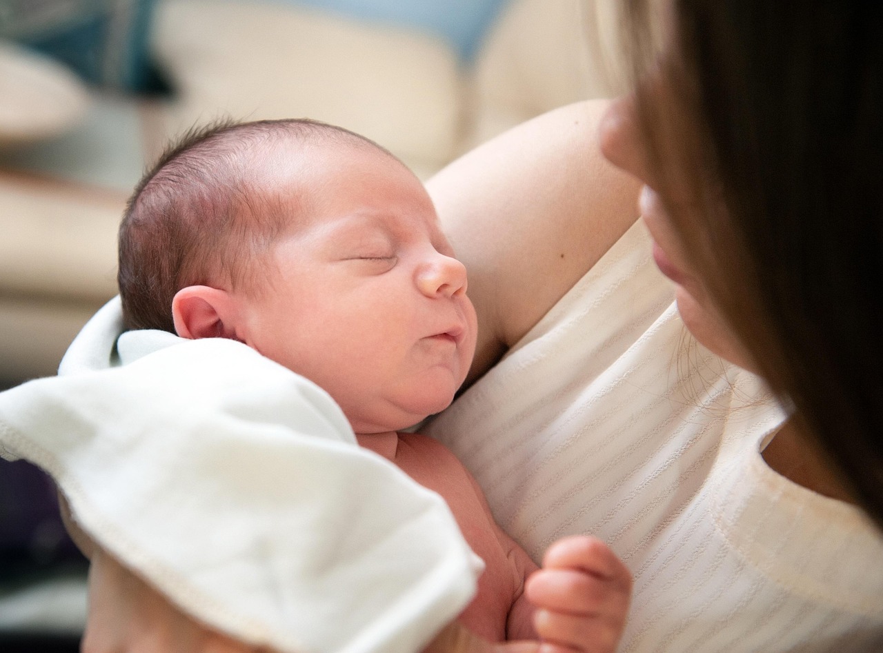 Newborn care specialist in Charlotte soothing a sleeping infant at night