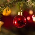 Holiday nanny hiring in Savannah — family decorating a Christmas tree