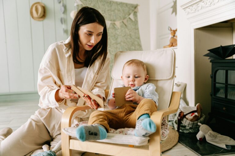 Woman reading to a baby in a nursery chair