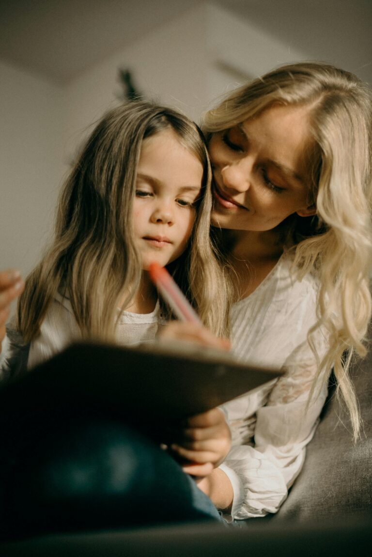 Woman helping a girl read a book