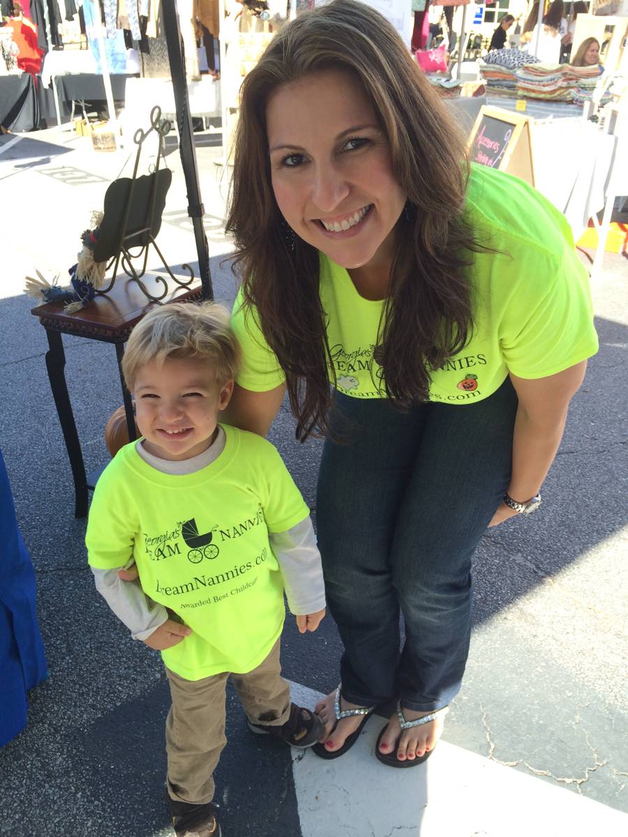 Serra Deville, founder of Georgia’s Dream Nannies, with her son at a community event wearing Georgia’s Dream Nannies shirts